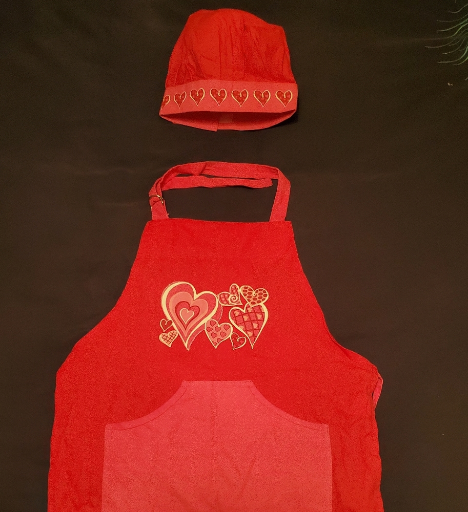 Little girl cooking apron and bakers hat